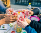 Picture of multiple people clanking cups together.